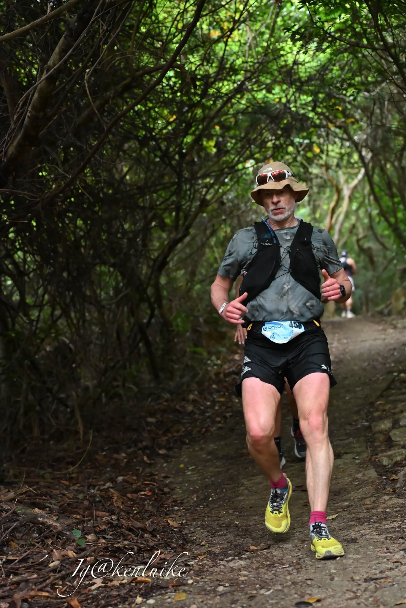 Rich Cowler racing through a forest wearing TOPO bib 458
