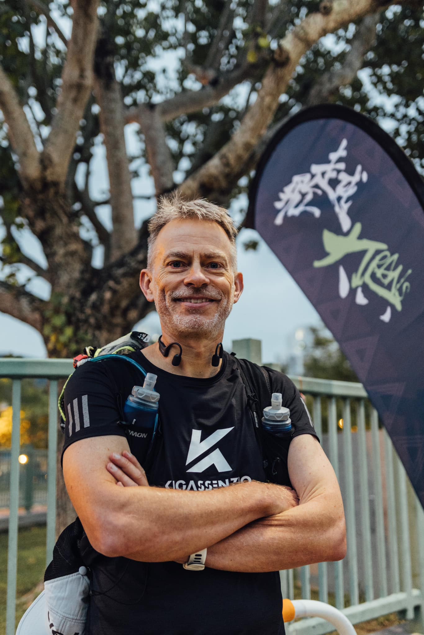 Rich Cowler portrait in front of a Rakuten Trails event banner